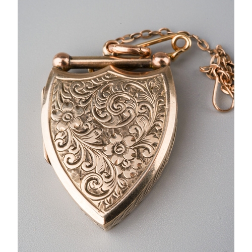 507 - An Edwardian locket, the shield shape locket with foliate embossed detail, approx length of locket 3... 