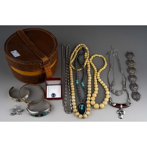 509 - A vintage collar box containing jewellery, including a sterling E. Benally gem set bangle, a white m... 