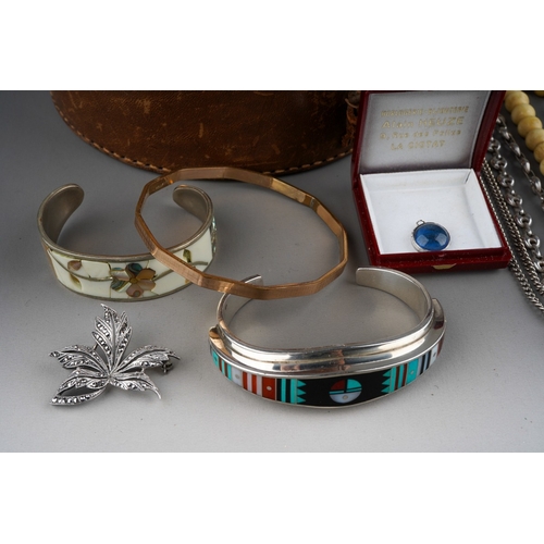 509 - A vintage collar box containing jewellery, including a sterling E. Benally gem set bangle, a white m... 