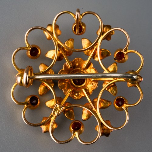 510 - An Edwardian 9ct gold garnet and seed pearl brooch. Of openwork design, set with garnet and seed pea... 