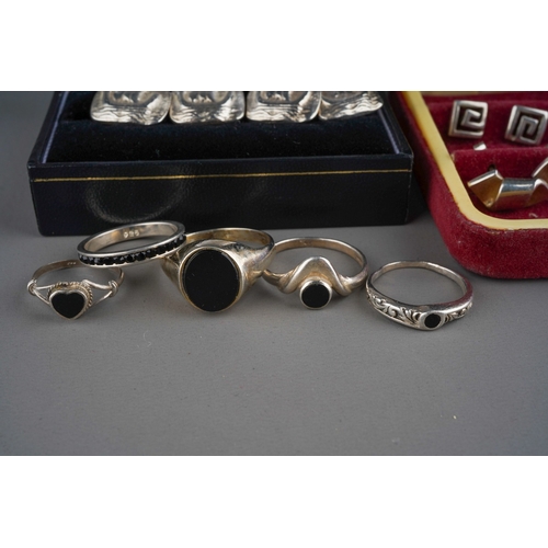 628 - A pair of silver cufflinks with boats (14g) , 5 silver rings set with black gemstones (11g) and 6 si... 