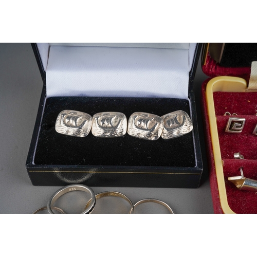 628 - A pair of silver cufflinks with boats (14g) , 5 silver rings set with black gemstones (11g) and 6 si... 