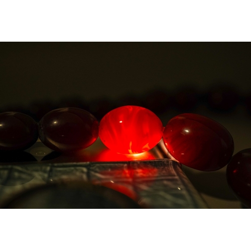 648 - String of Cherry Amber / Faturan beads, good internal streaking, gross weight 78 grams