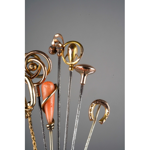 654 - A collection of four gold and yellow metal hat pins and four gold and yellow metal stock pins, inclu... 