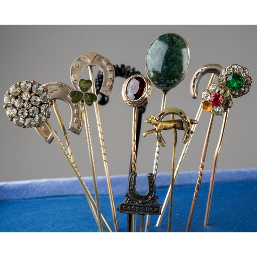 655 - A collection of twelve Victorian and later yellow metal, white metal and base metal stick pins, some... 