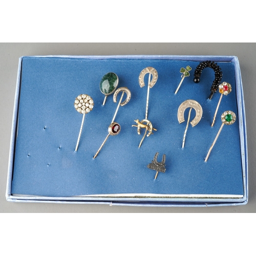 655 - A collection of twelve Victorian and later yellow metal, white metal and base metal stick pins, some... 