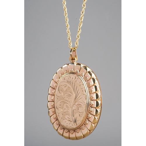 663 - 9k gold large locket and chain, front engraved with flowers, marked 375 to back and to chain. Gross ... 