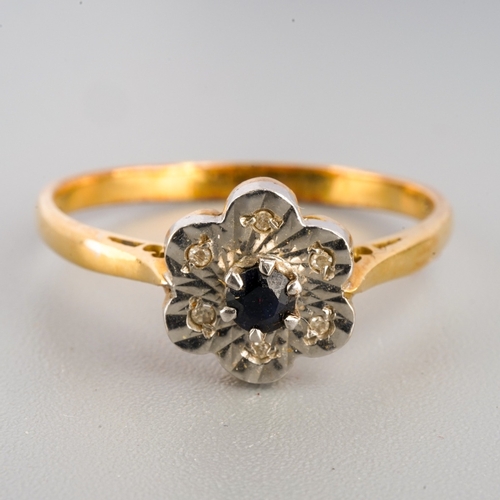 674 - An 18ct gold sapphire and diamond cluster ring, set with a central sapphire surrounded by single cut... 