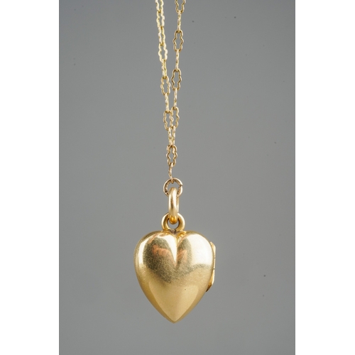 682 - 18 ct gold hear locket set with a ruby on a rolled gold chain, gross weight of heart locket 4.8g