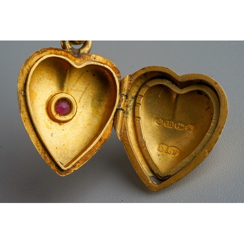 682 - 18 ct gold hear locket set with a ruby on a rolled gold chain, gross weight of heart locket 4.8g