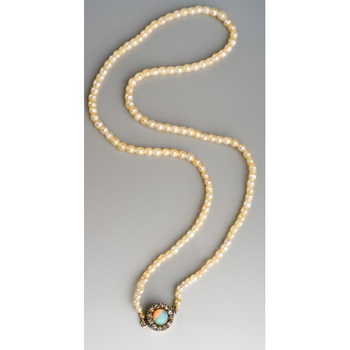 685 - An early 20th century seed pearl necklace with antique opal and rose cut diamond clasp, approx diame... 