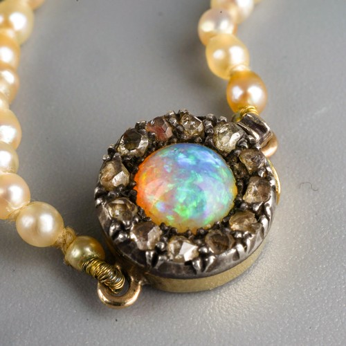 685 - An early 20th century seed pearl necklace with antique opal and rose cut diamond clasp, approx diame... 