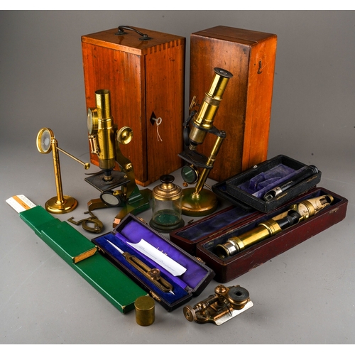 880 - A box containing a collection of scientific instruments, including two late 19th/ early 20th century... 