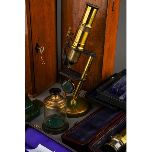 880 - A box containing a collection of scientific instruments, including two late 19th/ early 20th century... 