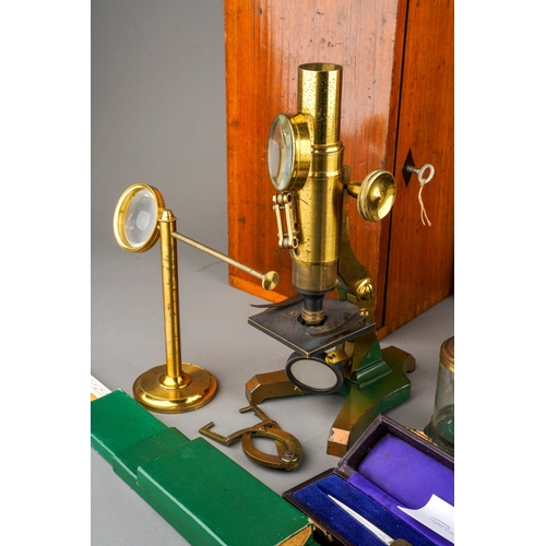 880 - A box containing a collection of scientific instruments, including two late 19th/ early 20th century... 