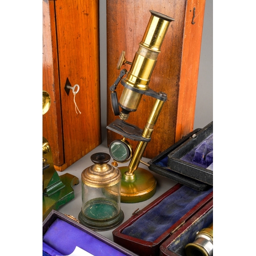 880 - A box containing a collection of scientific instruments, including two late 19th/ early 20th century... 