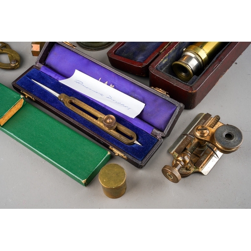 880 - A box containing a collection of scientific instruments, including two late 19th/ early 20th century... 