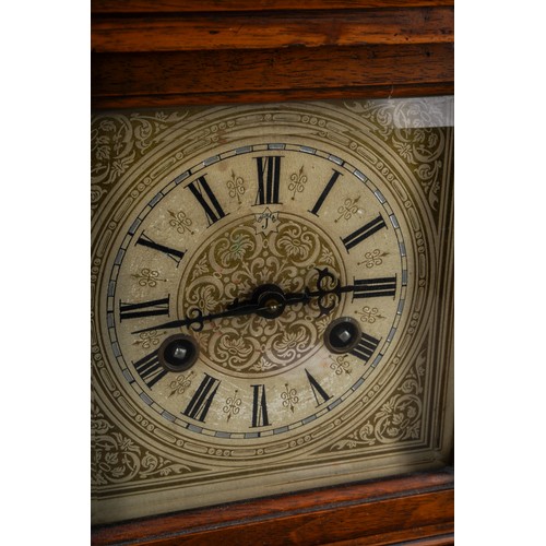 884 - A German oak cased mantle clock, silvered dial with Roman numerals, Architectural case with turned s... 