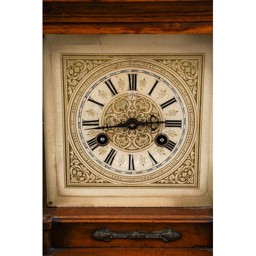 884 - A German oak cased mantle clock, silvered dial with Roman numerals, Architectural case with turned s... 