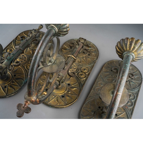 898 - A set of three late 19th century gilt brass and copper wall gas light fittings of Gothic style, roun... 