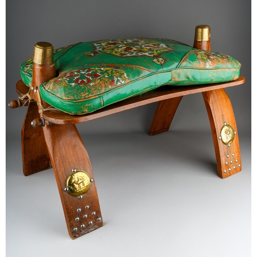 950 - A second half 20th century North African camel saddle with removable green leather cushion and decor... 