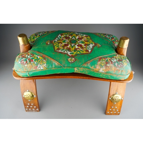 950 - A second half 20th century North African camel saddle with removable green leather cushion and decor... 