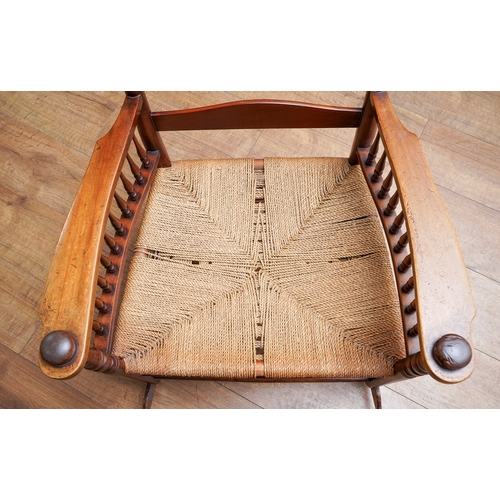 957 - A mahogany ladder back large rocking chair, balustrade arm supports, rope twist seat