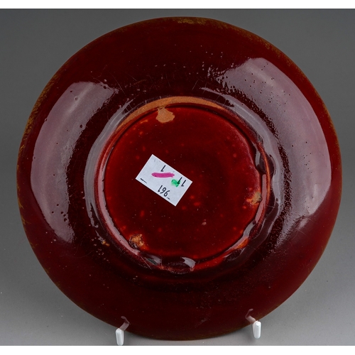 1001 - A late 19th century Japanese red glazed terracotta dish, the front with central white enamelled cran... 