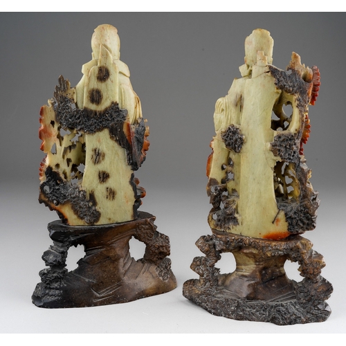 1014 - A pair of Chinese carved soapstone figures of deities on separate bases, height 25.5cm (2)