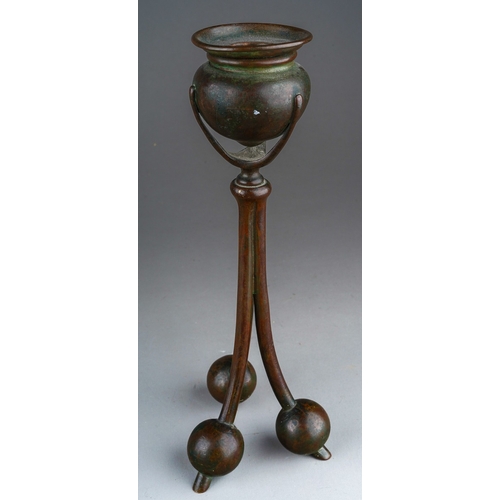 1015 - An early 20th Century American Tiffany Studios pattern no 2102 cast bronze candlestick with urn shap... 