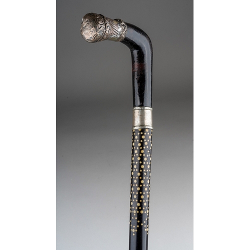 1028 - A late 19th century ebony and bone inlaid walking stick, the handle with white metal mount (soldered... 