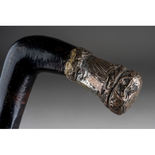 1028 - A late 19th century ebony and bone inlaid walking stick, the handle with white metal mount (soldered... 