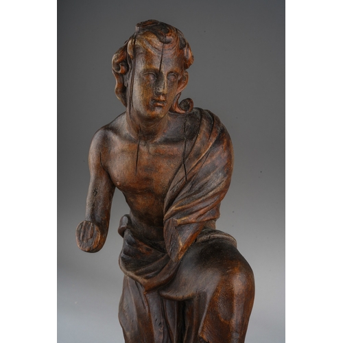 1029 - A 15th Century carved wood Northern European male figure kneeling and wearing draped robes, circular... 