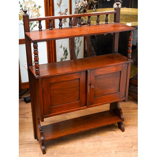 952A - A late Victorian walnut wall hanging cabinet, the raised back with turned gallery, the shelf support... 