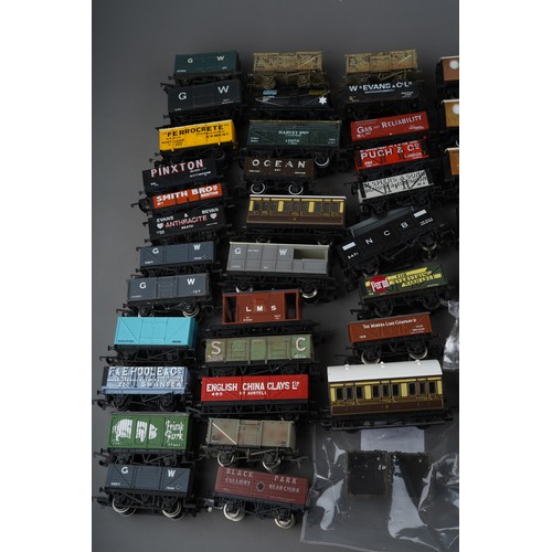 355 - Box of assorted OO Gauge loose wagons and coaches by Hornby, Bachmann etc