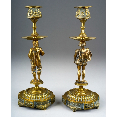 73 - A pair of late 19th century brass figural candlesticks, removable sconces the holders cast with foli... 