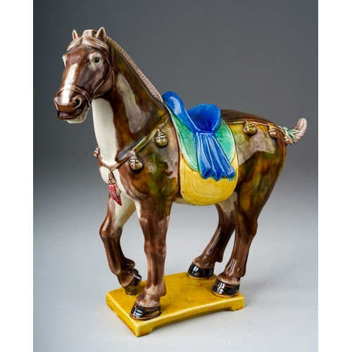 74 - A second half 20th century Chinese pottery figure of a Tang horse, impressed China to the underside,... 