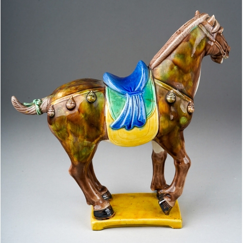 74 - A second half 20th century Chinese pottery figure of a Tang horse, impressed China to the underside,... 