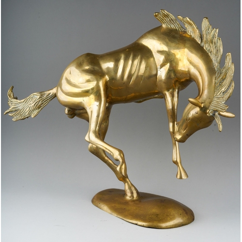 77 - A second half 20th century brass figure of a frolicking Stallion, on an oval base, height 45cm x len... 