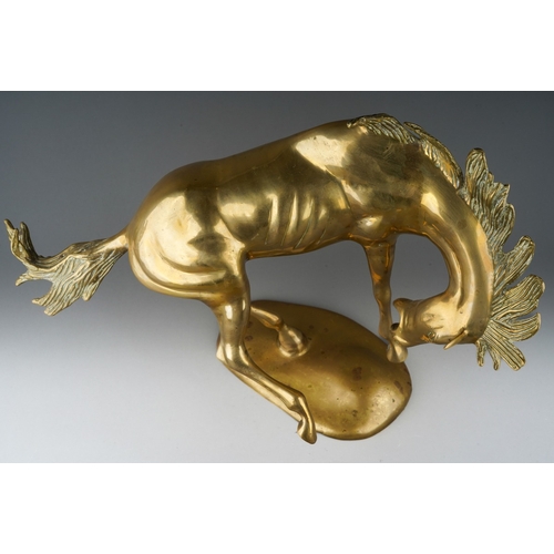 77 - A second half 20th century brass figure of a frolicking Stallion, on an oval base, height 45cm x len... 