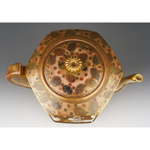 100 - A Japanese Satsuma pottery Meiji period (1868 to 1912) tea pot of waisted hexagonal form on three sh... 