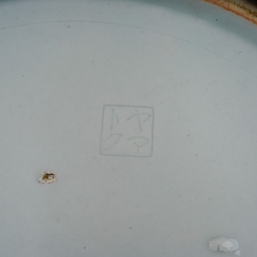 103 - A Japanese porcelain plate, enamelled with a green lotus and wavy line border and portrait of a man ... 