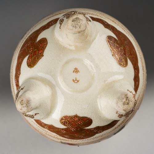106 - A small Japanese Satsuma pottery vase of ovoid form on three short legs, hand decorated with a conti... 