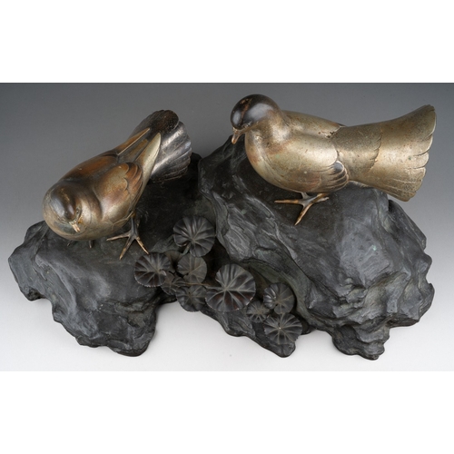 115 - An early 20th Century Japanese Showa Period (1926 to 1989) bronze of two birds on a naturalistic bas... 