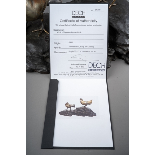 115 - An early 20th Century Japanese Showa Period (1926 to 1989) bronze of two birds on a naturalistic bas... 