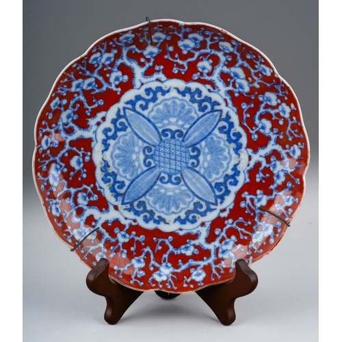 117 - A 19th century Japanese wavy rimmed plate, underglaze blue prunus blossom decoration on an over pain... 