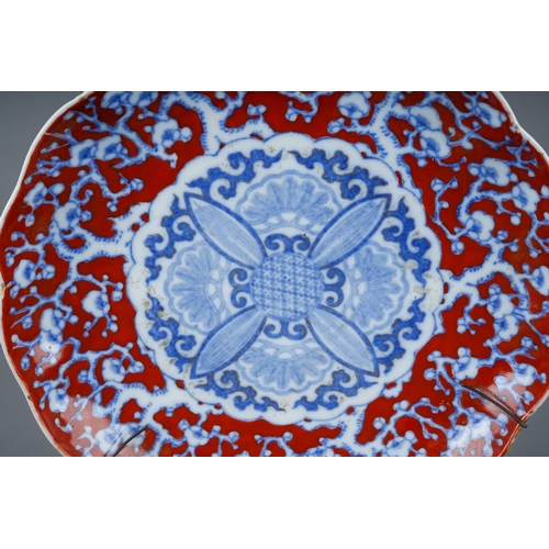 117 - A 19th century Japanese wavy rimmed plate, underglaze blue prunus blossom decoration on an over pain... 