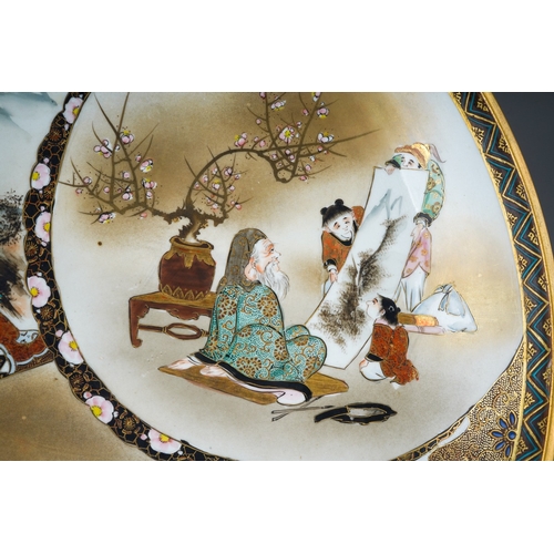 122 - A Japanese Kutani porcelain charger, Meiji period (1868-1912), geometric border surrounding three pa... 