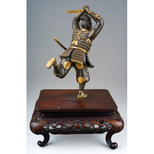 130 - A Japanese Meiji period (1868-1912) parcel gilt bronze figure of a Samurai warrior with sword, finel... 