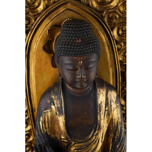 132 - An Edo period (1615-1868) lacquered giltwood figure of Amida Nyorai, glass urna, both hands in raigo... 